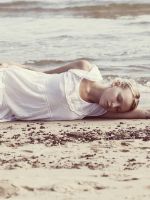 Blonde-Girl-Lying-On-Beach
