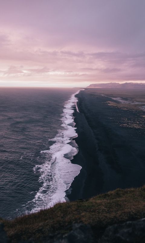 waves crashing on shore under cloudy sky during da... wallpaper