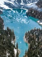 aerial photo of snow covered mountain near body of... wallpaper