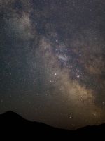 silhouette of mountain under stars wallpaper