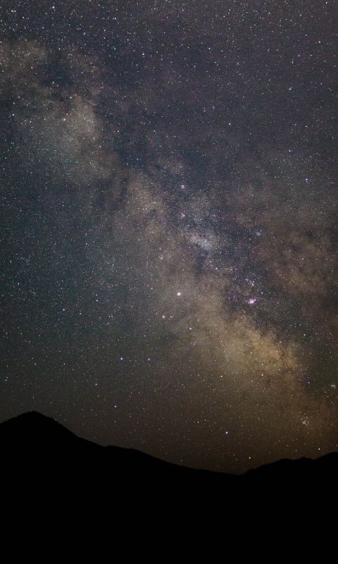 silhouette of mountain under stars wallpaper