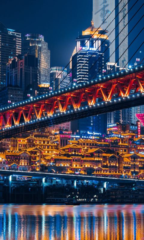 lighted bridge across calm water wallpaper