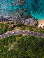 aerial view of road near body of water during dayt... wallpaper