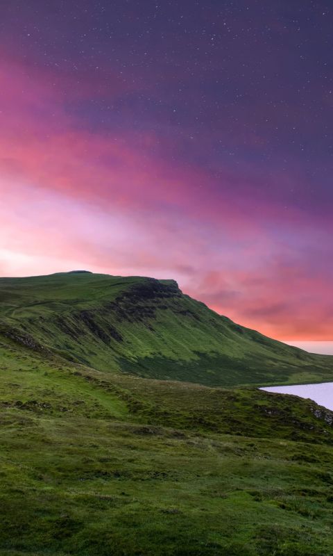 green mountain under purple sky wallpaper