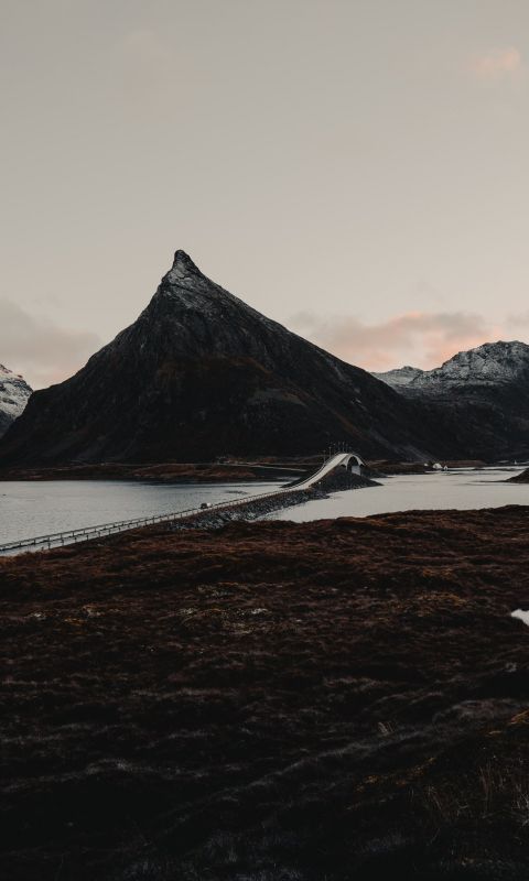 mountains beside bridge wallpaper