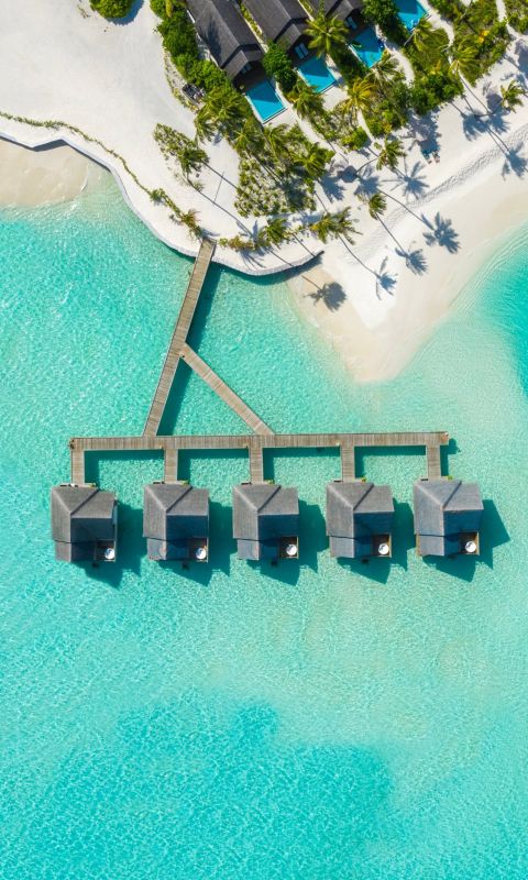 brown huts on body of water in aerial photography wallpaper