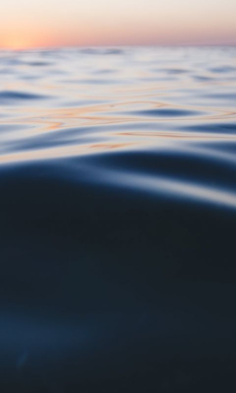 photo of calm sea water during daytime wallpaper