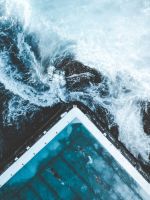 aerial view of ocean beside dock wallpaper
