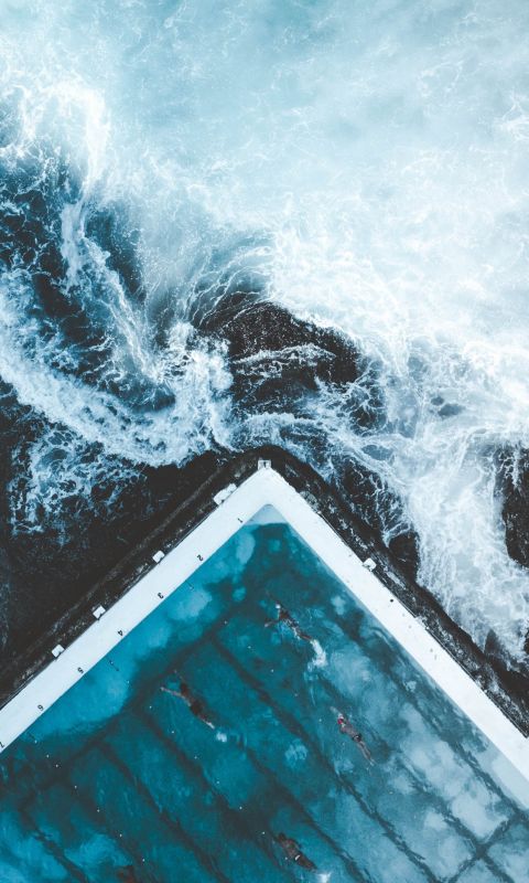 aerial view of ocean beside dock wallpaper