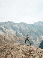person standing on mountain scenery wallpaper