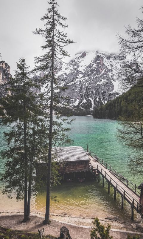 person standing near body of water wallpaper