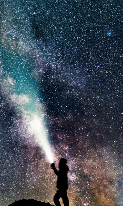 a sefie underneath the milky way wallpaper
