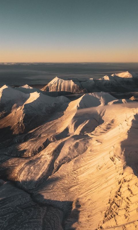 brown and white mountains under blue sky during da... wallpaper