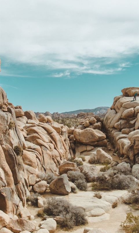 gray rocks under cloudy sky wallpaper