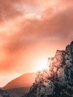 black and gray hill under cloudy sky during sunset wallpaper